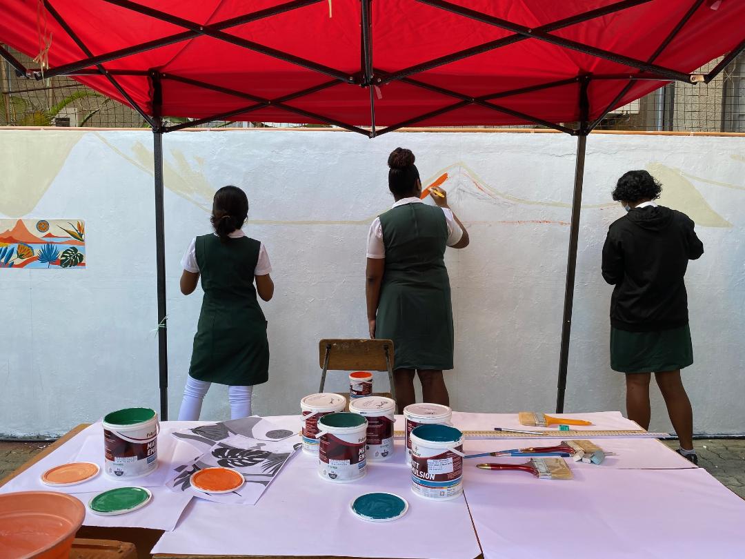 Students painting a wall mural
